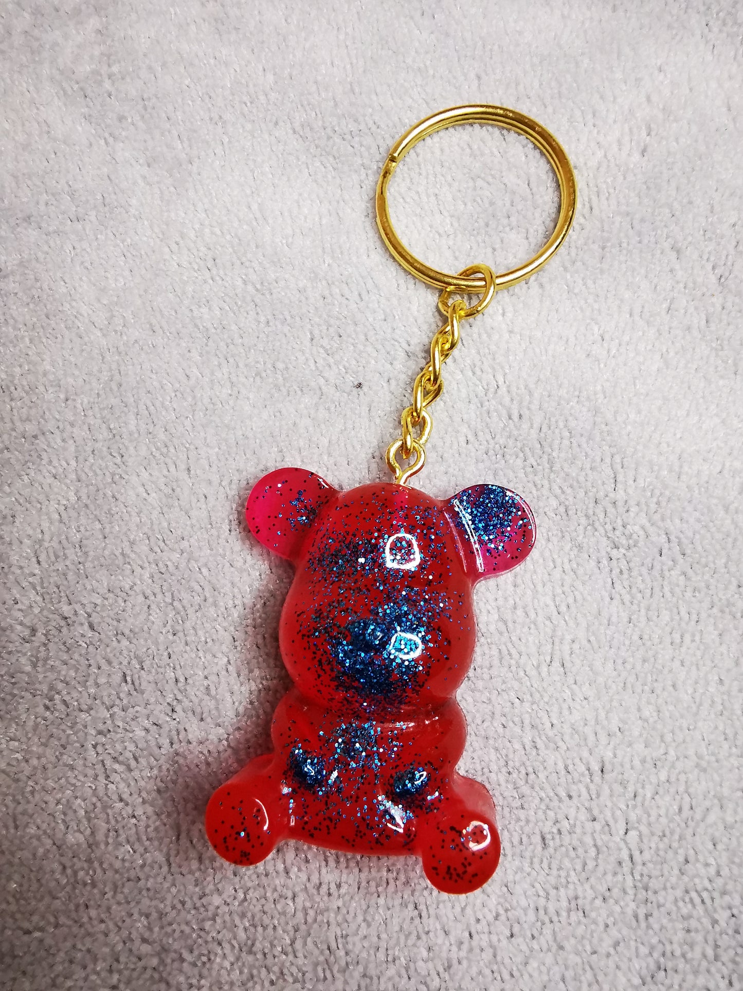 Porte clé ourson rouge/rose pailleté bleu