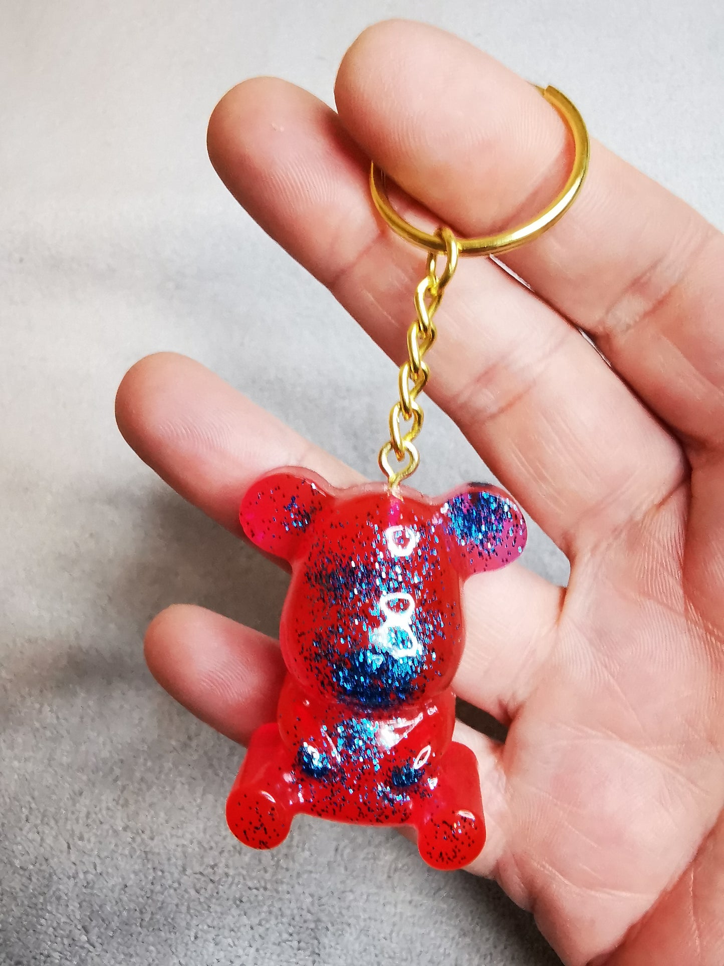 Porte clé ourson rouge/rose pailleté bleu